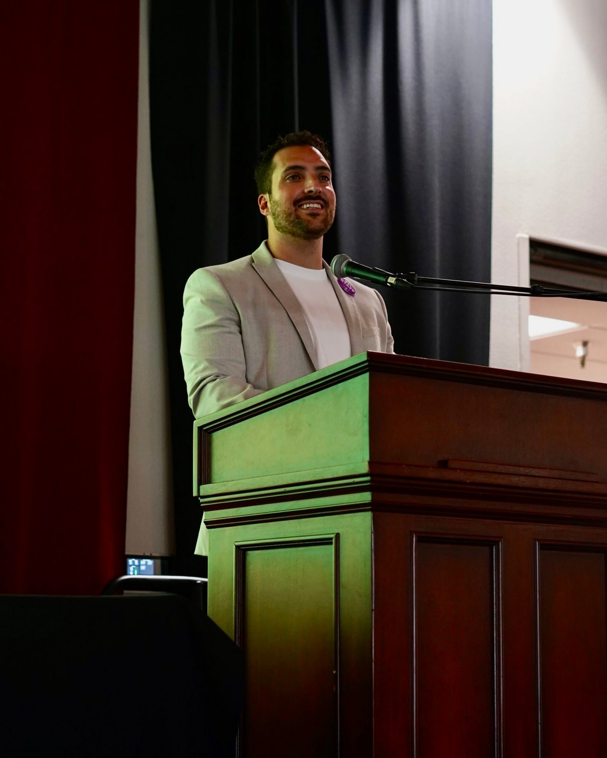 Alejandro Gutierrez speaking at a podium
